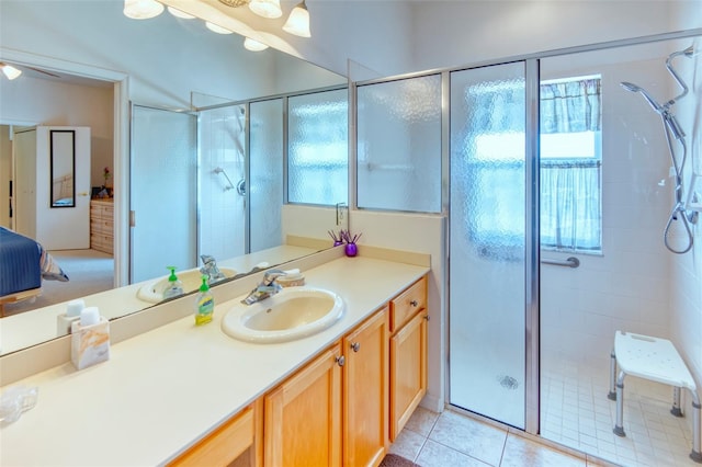 bathroom with tile patterned flooring, vanity, and an enclosed shower