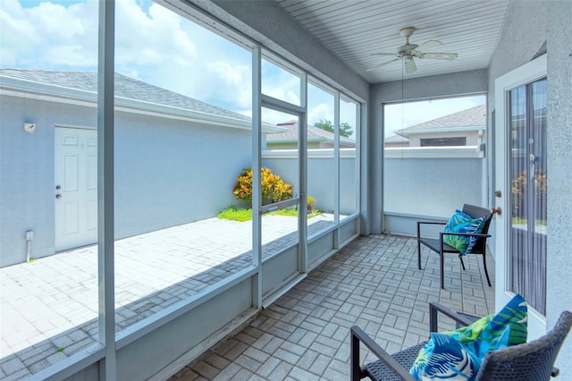 sunroom / solarium featuring ceiling fan