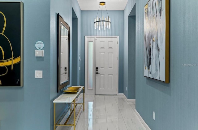 foyer entrance with a chandelier