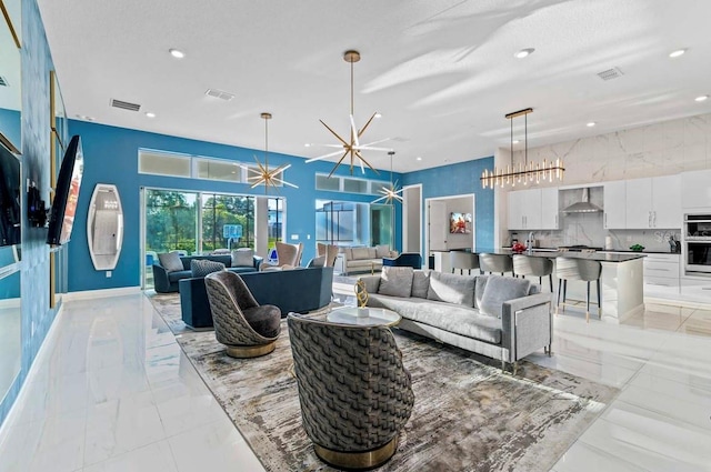 living room with sink and a chandelier