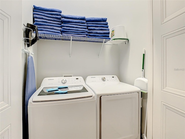 clothes washing area featuring washer and clothes dryer