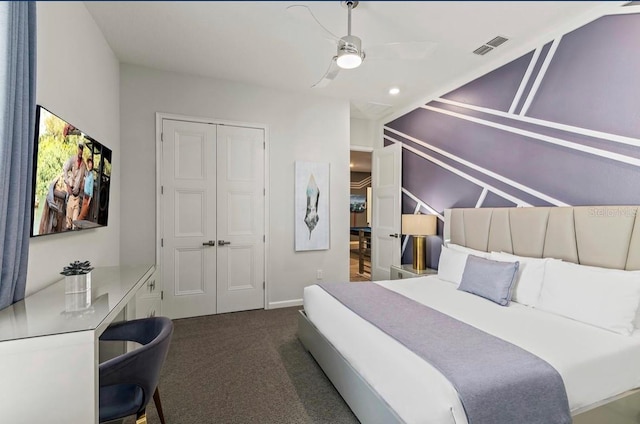 carpeted bedroom with ceiling fan and a closet