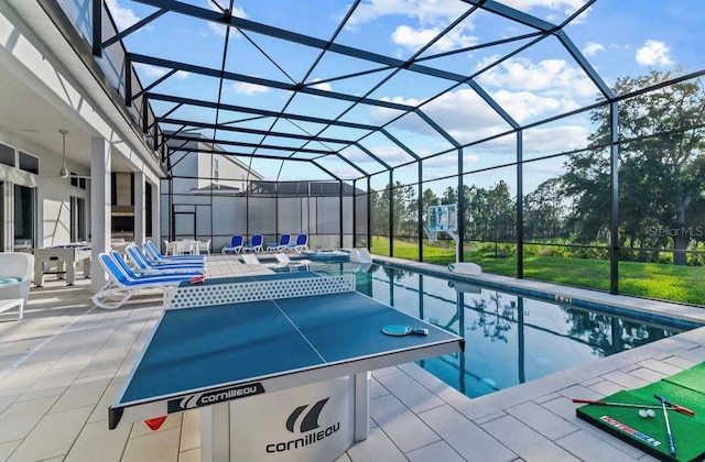 view of pool featuring glass enclosure, a patio area, and a hot tub