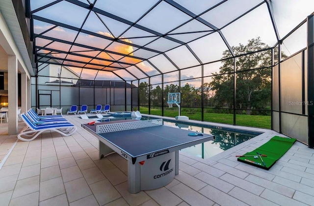 patio terrace at dusk with a pool with hot tub and a lanai