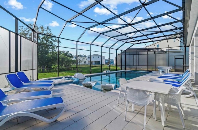 view of pool with a lanai, a jacuzzi, and a patio