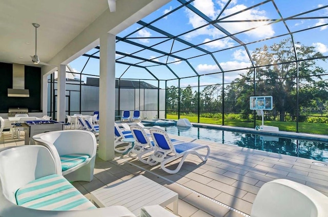 exterior space featuring a lanai, a patio, an outdoor kitchen, and ceiling fan