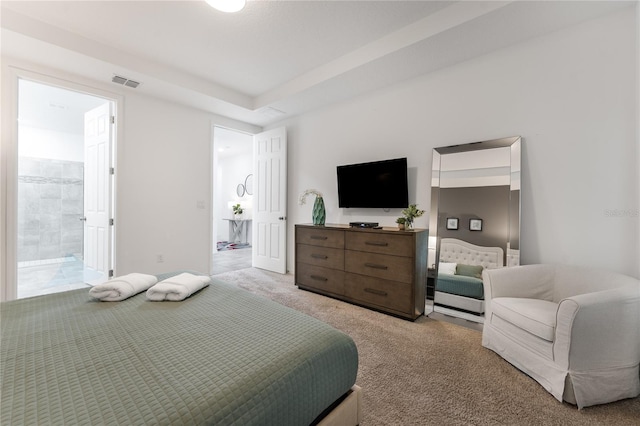 carpeted bedroom featuring ensuite bathroom