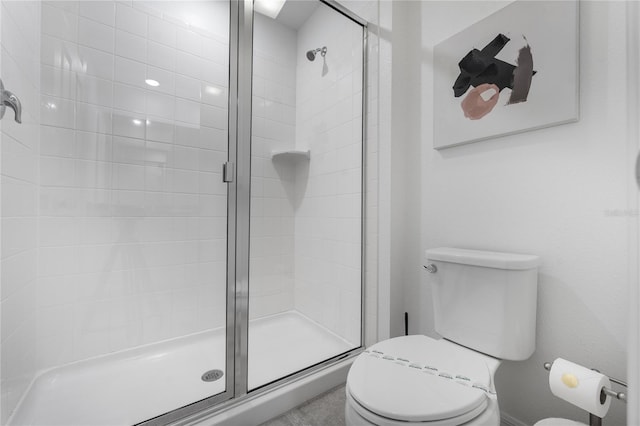 bathroom featuring walk in shower and toilet