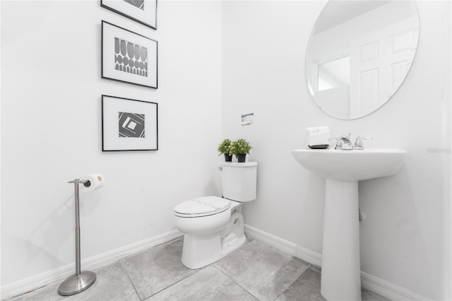 bathroom featuring tile patterned flooring and toilet