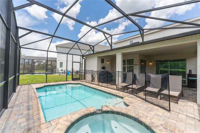 view of swimming pool with an in ground hot tub, a lanai, and a patio