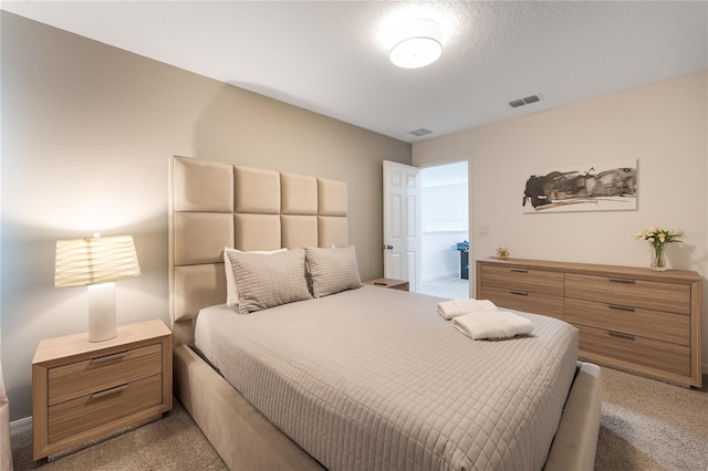 carpeted bedroom with ensuite bath