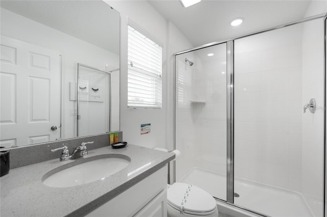 bathroom with vanity, an enclosed shower, and toilet