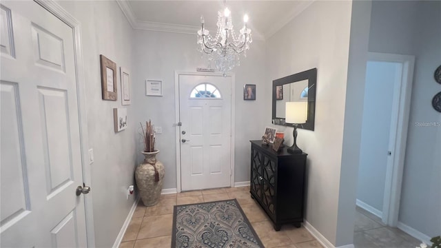 tiled foyer featuring a notable chandelier and crown molding