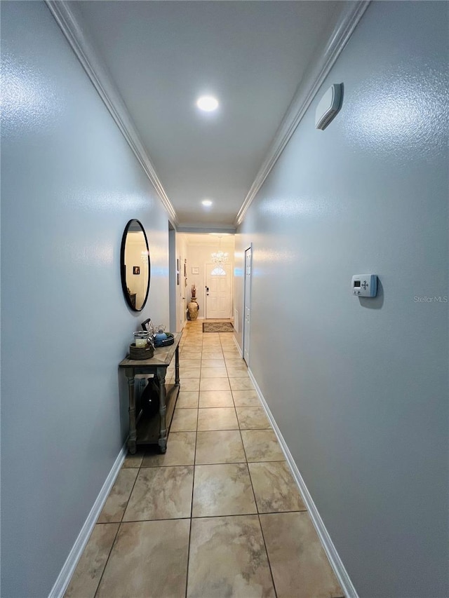 hallway featuring light tile patterned flooring and ornamental molding