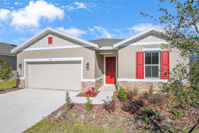2043 Stetson Ct, Eagle Lake, FL 33839 - view of front of property with board and batten siding, stone siding, an attached garage, and concrete driveway