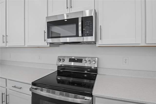 kitchen with white cabinetry and appliances with stainless steel finishes