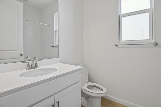 bathroom featuring toilet, vanity, a shower, and tile patterned floors