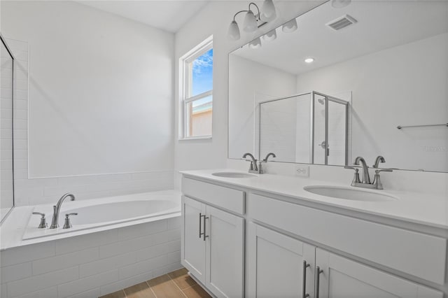 bathroom featuring separate shower and tub and vanity