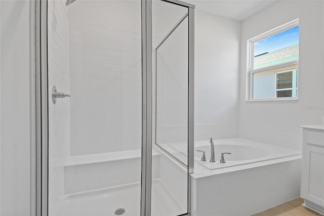 bathroom with separate shower and tub and vanity