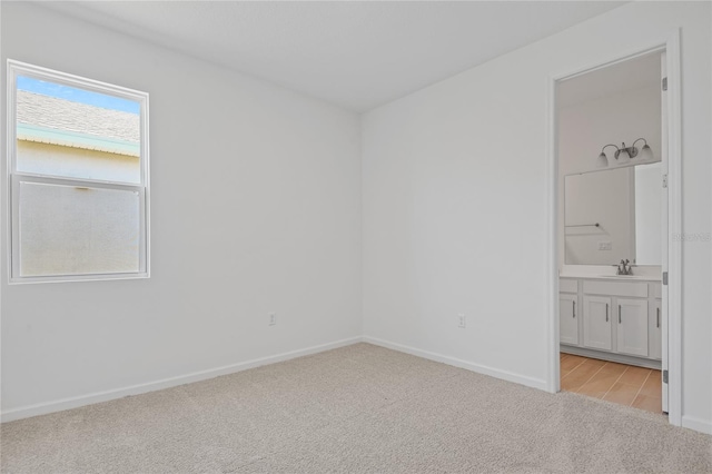 carpeted empty room featuring sink