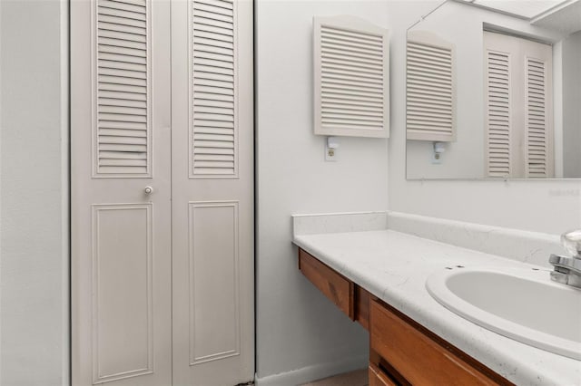 bathroom featuring a closet and vanity