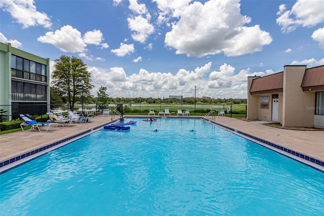 pool featuring a patio and fence