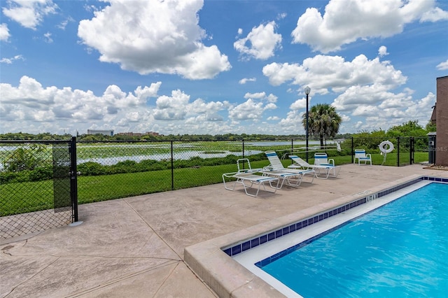 community pool featuring fence and a patio
