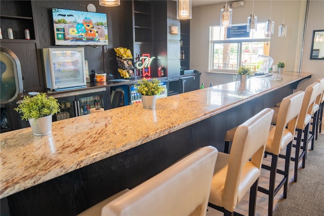 kitchen featuring pendant lighting, a kitchen breakfast bar, and carpet floors