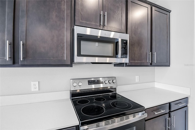 kitchen featuring appliances with stainless steel finishes and dark brown cabinets