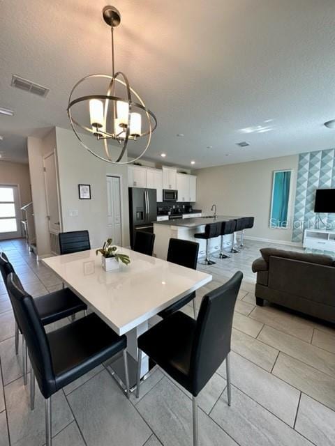 dining area featuring a notable chandelier and light tile patterned floors