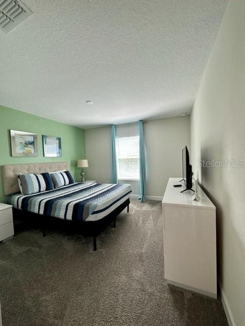 bedroom with light colored carpet and a textured ceiling