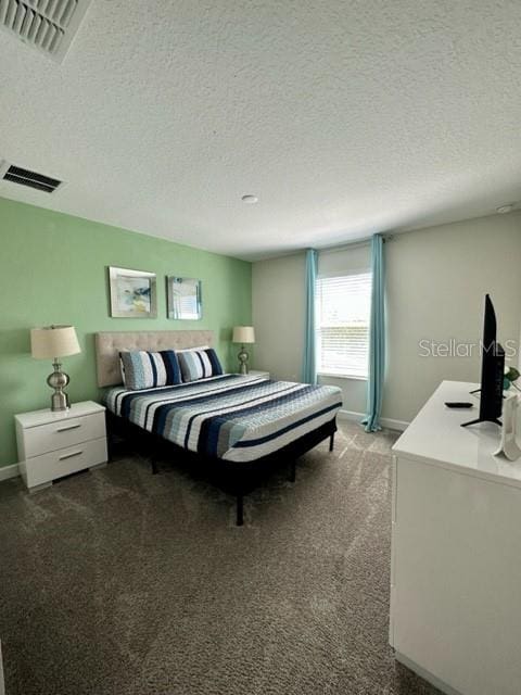 carpeted bedroom with a textured ceiling