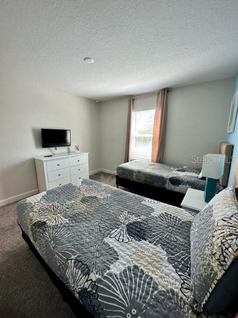 carpeted bedroom with a textured ceiling