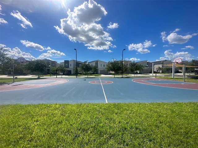 view of sport court with a yard