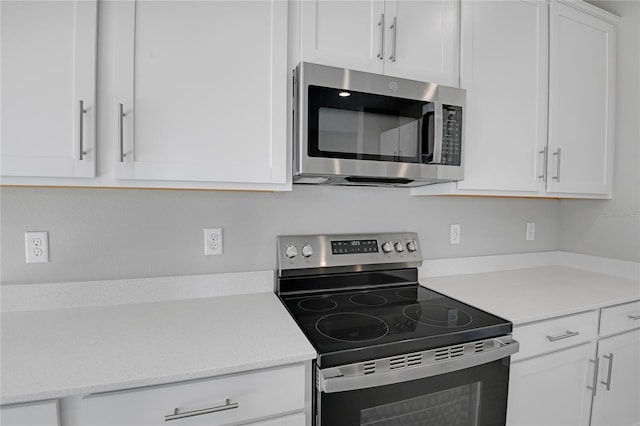 kitchen featuring stainless steel appliances and white cabinets