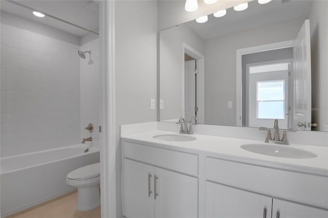 full bathroom featuring toilet, vanity, and  shower combination