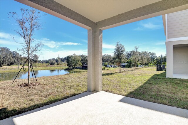 view of patio featuring a water view and central air condition unit