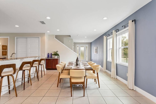 dining area featuring light tile patterned flooring