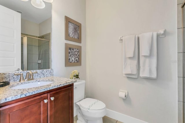 bathroom featuring tile patterned flooring, vanity, and toilet