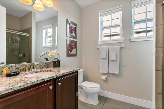 bathroom with tile patterned flooring, toilet, vanity, and a shower with shower door