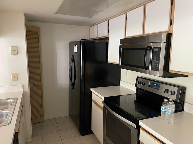 2022 Royal Bay Blvd Unit 93, Kissimmee, FL 34746 - kitchen with light countertops, a sink, light tile patterned floors, and appliances with stainless steel finishes
