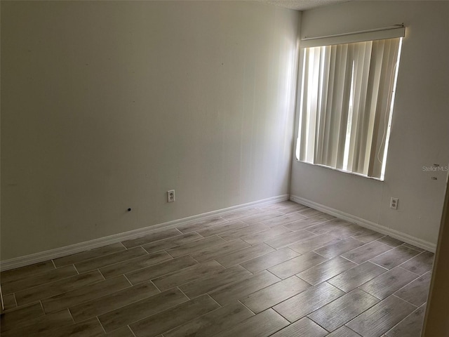 unfurnished room with hardwood / wood-style floors