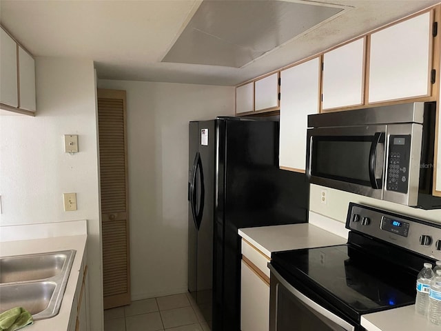 2022 Royal Bay Blvd Unit 93, Kissimmee, FL 34746 - kitchen with light countertops, a sink, stainless steel appliances, and light tile patterned floors