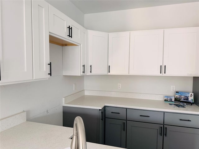 kitchen featuring light countertops, white cabinetry, and gray cabinetry