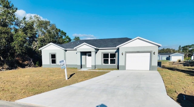 ranch-style home featuring an attached garage, a front lawn, concrete driveway, and stucco siding