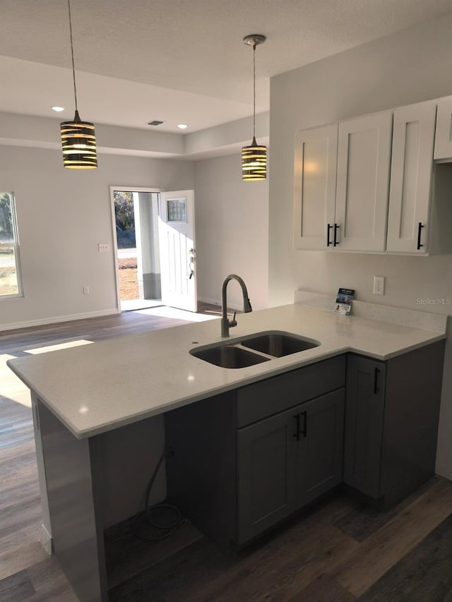 kitchen featuring a wealth of natural light, light countertops, and a sink