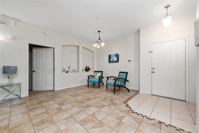 entryway featuring a chandelier and light tile patterned floors