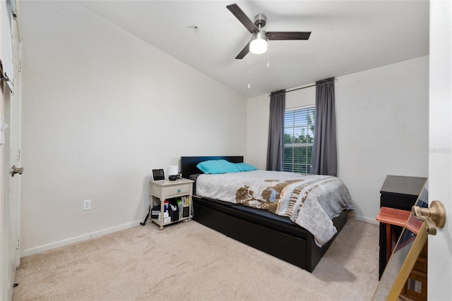 carpeted bedroom featuring lofted ceiling and ceiling fan