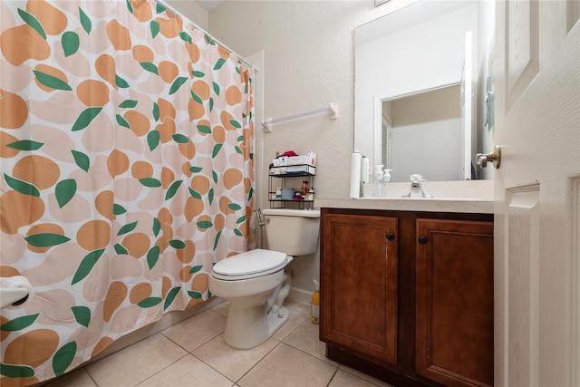 bathroom with vanity, tile patterned floors, and toilet