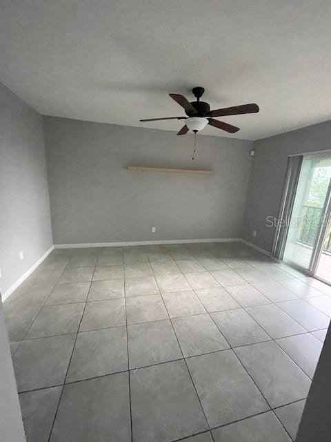 empty room featuring ceiling fan and light tile patterned floors